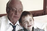 Picture of the author as a child with their grandfather