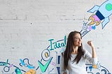 empowered woman with whiteboard ideation drawings behind her