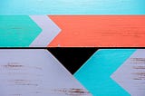 Painted arrows on wood facing different directions