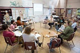 high school students in a circle in a classroom