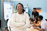 A smiling black woman in an office