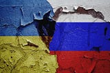 Ukraine vs Russia War tattered Flags. Image Credits (Shutterstock)