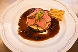 Slices of lamb fillet with mint and pepper sauce