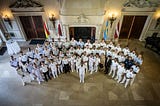 A group of people in military uniform standing in a hall