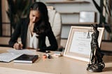 A paper diploma framed on a desk