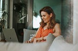 Smiling woman at work on her laptop