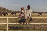 https://www.pexels.com/photo/couple-sitting-on-a-fence-on-a-farm-18254570/