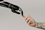 Robotic hand and human hand reaching each other
