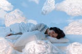 woman asleep, her bed drifting in the sky surrounded by puffy, white clouds