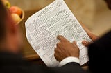 A picture of President Obama reviewing his handwritten edits to a printed draft of a speech.