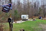 A MAGA Republican flies a “Let’s Go Brandon” flag outside his trailer