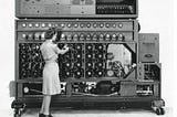 A woman adjusting a large machine