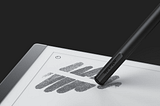 Cropped picture of stylus rubbing out an image appearing on the Remarkeable two e ink display screen