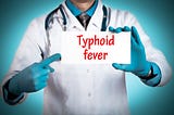 A medical personnel indicating what typhoid fever is.