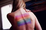 Bisexual woman with gay flag on back.