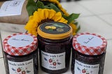 Photo of 3 jam jars and a sunflower