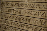 A wall of carved hieroglyphs. Image by RGY23 from Pixabay.