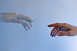 A robot and human hands reaching for eachother.