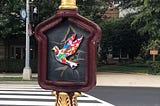 A street sign depicting a colorful bird near DuPont in Washington DC