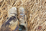 Two muddies shoes, one dug up from two feet of mud.