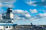 beautiful blue sky, and a small airport with plane outside