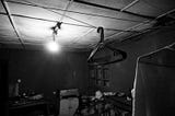 A B&W picture of a clothesline in an old kitchen. The kitchen was the place where families congregated their live on.