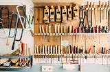 Carpenters workshop with tools on rack.