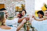 Friends dining outside and enjoying wine.