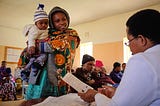 A mother enrolled in MomCare receives a postnatal check-up in Tanzania