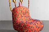 A sculpture formed in a shape of a chair.