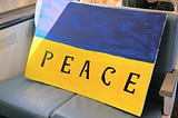 Sign of Ukraine’s flag with “peace” written on it