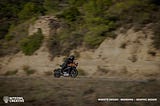 A motorcycle driving fast, with Niteowl Creative’s logo about website design
