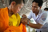 Young boy receiving a routine vaccine from a healthcare professional in a clinic, illustrating vaccine safety and pediatric immunization.