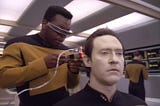 Geordi LaForge doing diagnostics on Data on Star Trek