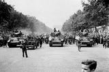 LIBERATION OF PARIS 26 AUGUST 1944 PARIS, FRANCE: The crowd of Parisians led by armoured cars of the French Division form a huge procession along Champs Elysees during the celebration of the capital. (Courtesy of Peter Deleuran & TopFoto.co.uk).