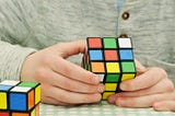 a person playing a rubik square game