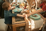 family holding hands at Thanksgiving dinner
