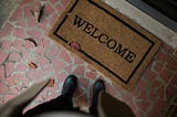 A welcome mat in front of a door