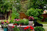 photo of firepit herb garden and other potted flowers surrounding it