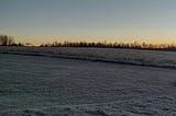 Sunrise over a field.