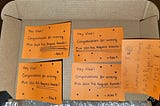 A paper box cap with 5 orange post-its that have a slightly different layout and handwriting. They al write: “Hey Vlad! Congratulations for winning Miro 2024 Pull Request Awards! — Alex P.”