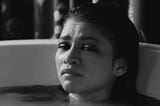 Marie (Zendaya) in a close up of her face during a traumatic bath scene in the Movie Malcolm and Marie.