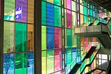 A staircase in front of the colourful windows at the Palais de Congrès in Montreal, Canada, where CHI 2006 and CHI 2018 were held. Image credit: Société du Palais des congrès de Montréal Royalty Free Photos.