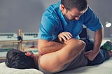 Chiropractor adjusting a patient in the office — www.brijbaglaw.com