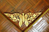 A golden bee in the rooftop corner of a house in Myanmar