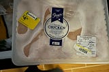 Frozen chicken with a “quick sale $4.51” sticker on it.