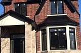 Dark Red Brick house with Black Roof