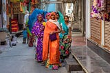 Group of sari-wearing women standing in the street