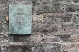 Buddha plaque on stone wall