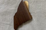 The state of Maine, cut from a slab of walnut.